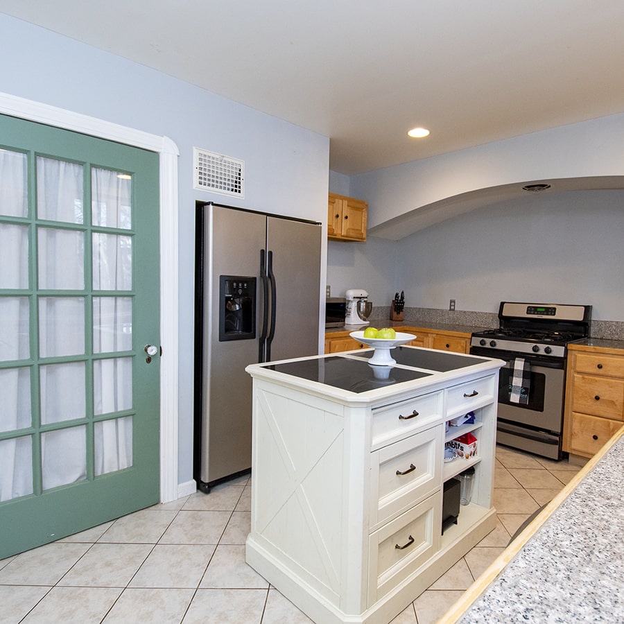 Reimagine Renovation renovated kitchen with green door