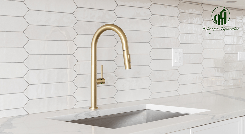 A modern gold faucet in a newly renovated kitchen