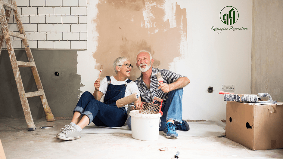 A couple sitting on the floor in the midst of a home renovation project