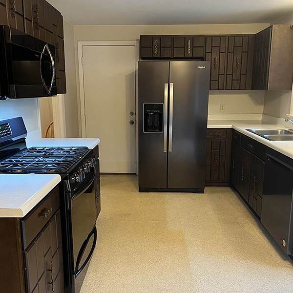 Outdated kitchen with dark cabinets