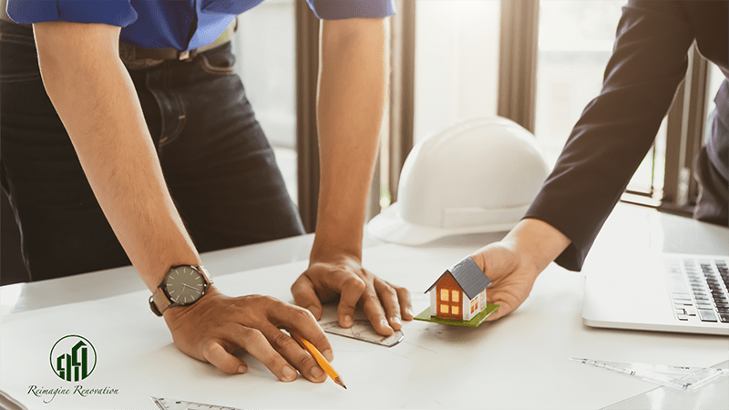 A homeowner and a general contractor looking at house plans