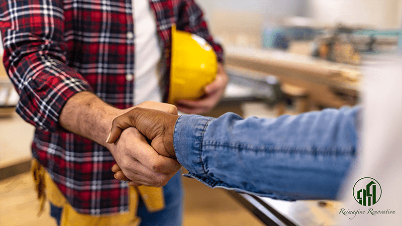 A contractor and a homeowner agreeing to work together and shaking hands