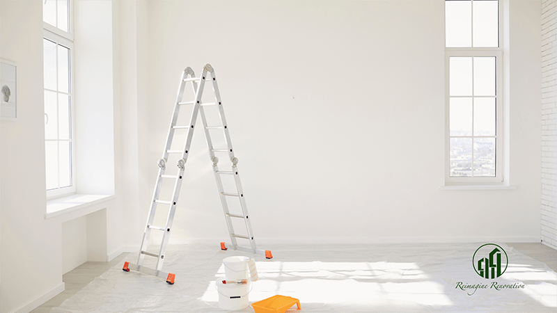 A room being renovated with white walls and a ladder