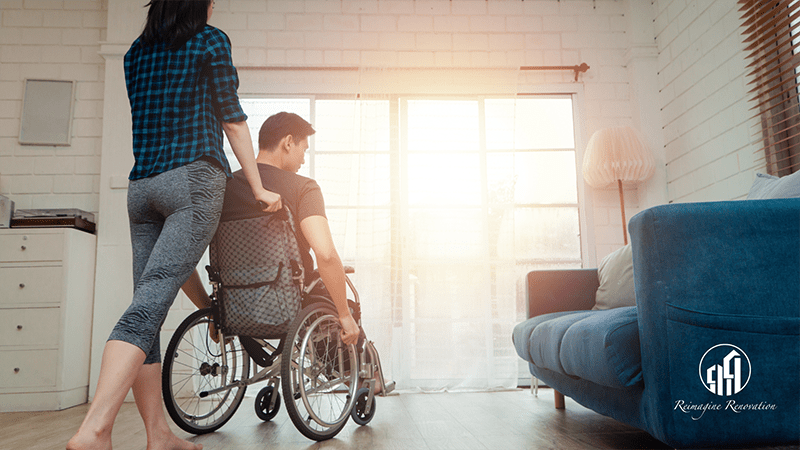 A woman pushing a man in a wheelchair