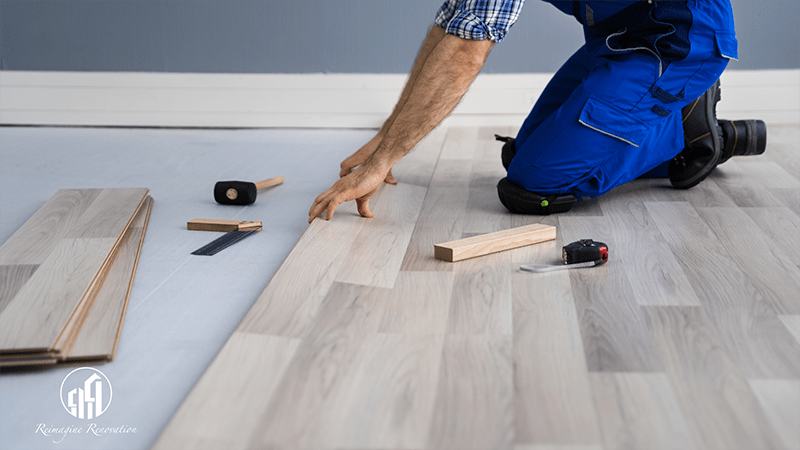 A carpenter installing a new wood floor