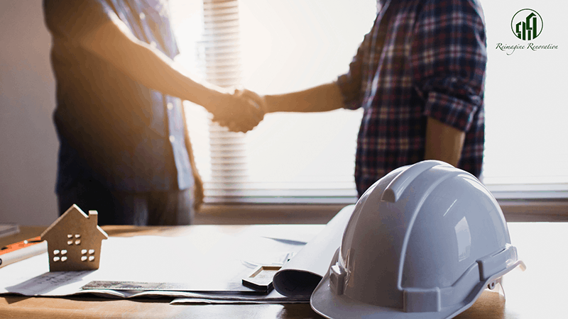 A homeowner and a contractor shaking hands
